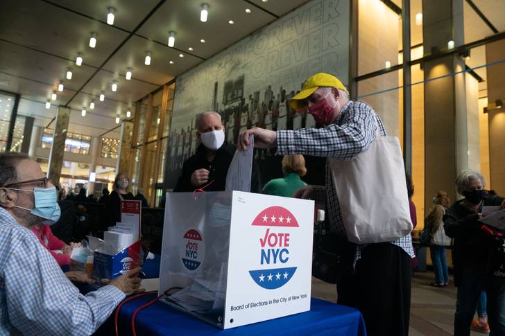 A man drops off an absentee ballot at Madison Square Garden on the first day of early voting in New York on October 2020.